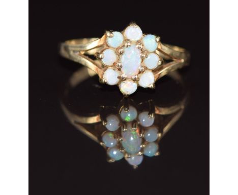 A 9ct gold ring set with opals in a cluster, 2.1g, size O