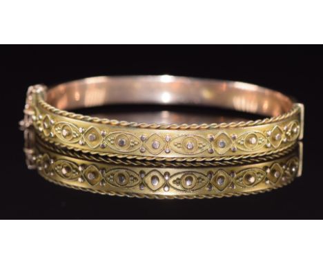 A 9ct gold bangle with applied decoration and rope twist border, 9.2g, 5.4 x 4.5cm&nbsp;