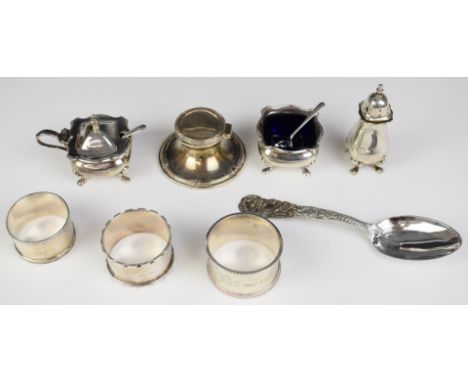 Hallmarked silver items comprising three napkin rings, Mappin &amp; Webb three piece cruet set and a capstan inkwell and a sp