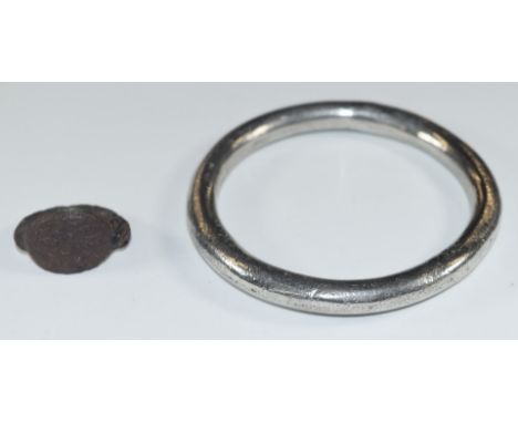 A possibly Celtic / Anglo Saxon hammered silver bangle, diameter 7cm, together with a possibly medieval ring