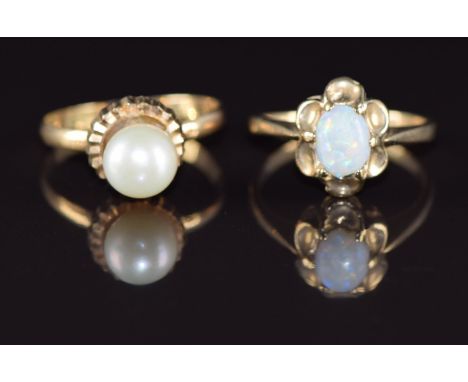 A 9ct gold ring set with an opal (1.9g, size J) and a yellow metal ring (testing as 14k) set with a pearl, 1.6g, size M