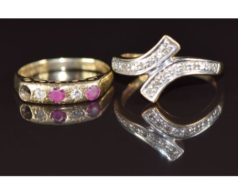 A 9ct gold ring set with diamonds in a cross over design (1.9g, size K) and a 9ct gold ring set with rubies and diamonds (one