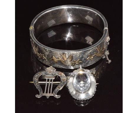 A hallmarked silver bangle with applied gold decoration, Victorian silver brooch / pendant and Victorian brooch in the form a