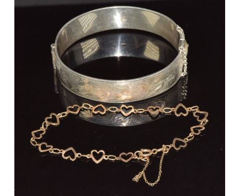 A 9ct gold bracelet made up of heart links (2.4g, 18cm) and a silver bangle with scrolling decoration&nbsp;