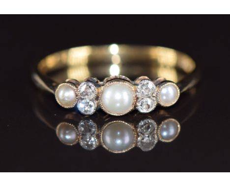 A c1910 18ct gold ring set with split pearls and old cut diamonds, 1.8g, size N