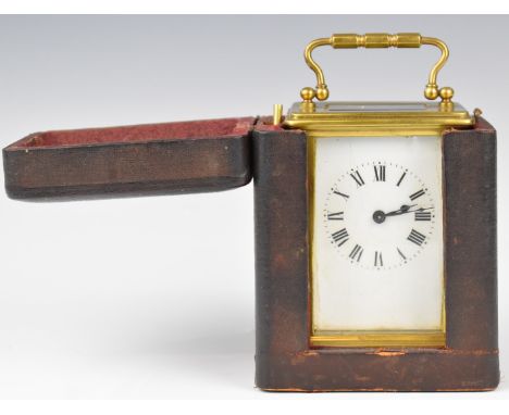 Brass cased carriage clock with white enamel dial and Roman numerals, marked to movement France, in leather travel case