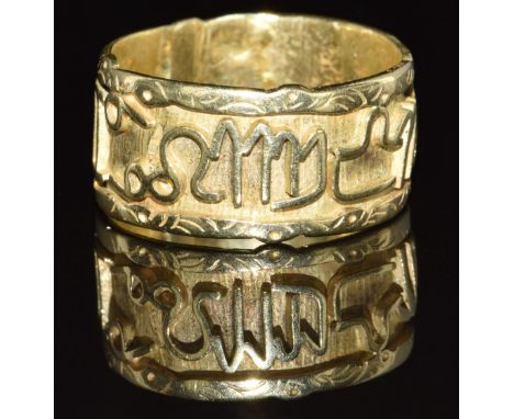 A yellow metal ring (tests as 18k) with symbol decoration, 5.9g, size R