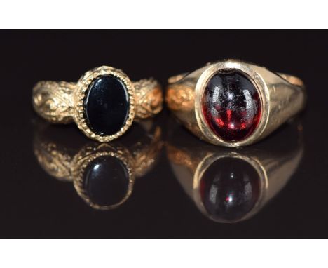 A 9ct gold ring set with a garnet cabochon (size N) and a 9ct gold ring set with onyx, size F, 5.1g&nbsp;