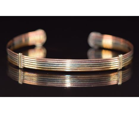 A 9ct gold tri-coloured bangle, 6.2g