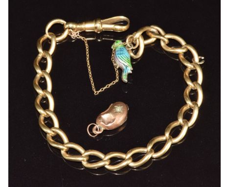 An 18ct gold bracelet made up of oval twisted links (24.6g) with a silver charm in the form of a parrot set with enamel and a