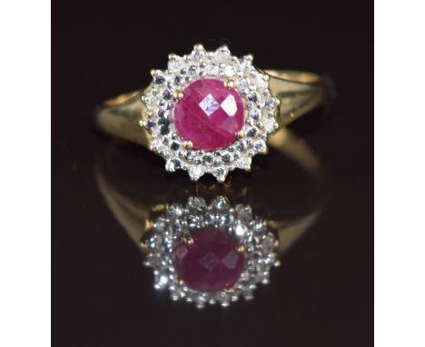 A 9ct gold ring set with a ruby of approximately 0.8ct surrounded by diamonds, 3g, size R