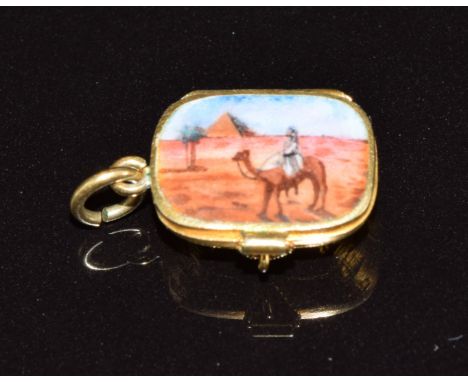 Egyptian Revival charm set with enamel depicting a camel and pyramid opening to reveal a miniature model of a baby, 1.3 x 1cm