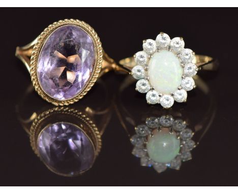 A 9ct gold ring set with an oval cut amethyst and a 9ct gold ring set with an opal cabochon surrounded by cubic zirconia, 6.5