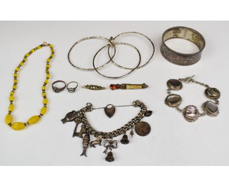 A silver bangle / cuff, another silver bangle made up of three bangles joined together, silver charm bracelet with eight char