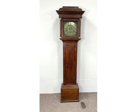 An early 18th century oak longcase clock, by Joseph Taylor, in an architectural provincial caddy topped case, inset with squa