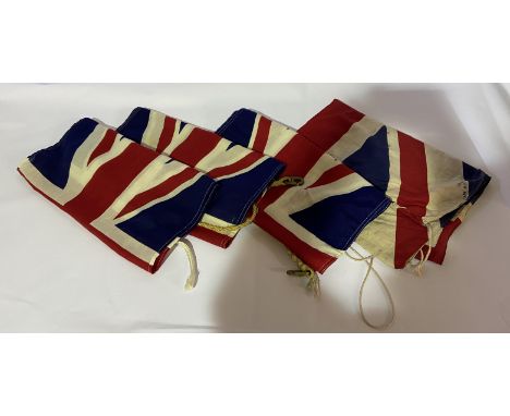 Four assorted Union Flags, three by repute are vintage Royal Navy Union Jacks from HMS Unicorn, the 1824 42 gun frigate, now 