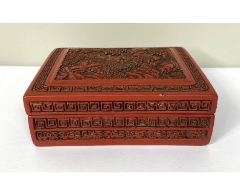 A Chinese export Cinnabar lacquered trinket box, 20th century, the top decorated with a tree lined landscape, 17cm wide By re
