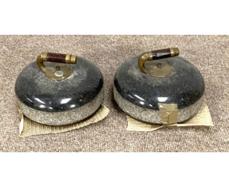 A pair of vintage Scottish curling stones, with brass and wood handles and polished tops (2)  The stones are 12cm to top of s