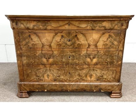 A Biedermeier walnut veneered commode, 19th century, with an ogee moulded frieze drawer over three further drawers, includes 