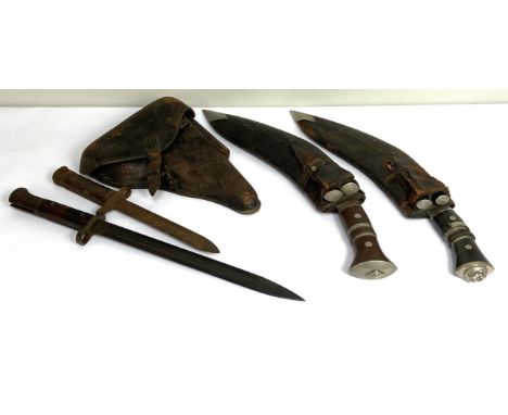 Two vintage Kukri, with sheaths and subsidiary knives, also a vacant wartime pistol holster and two bayonets (5)