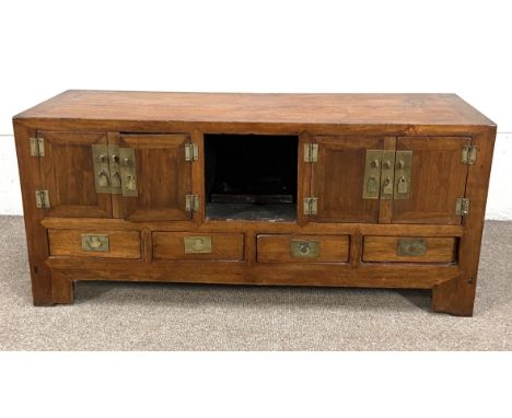 A modern Chinese hardwood (Nanmu) side cabinet, with brass mounts, and four short drawers on block feet 62cm high, 141cm wide