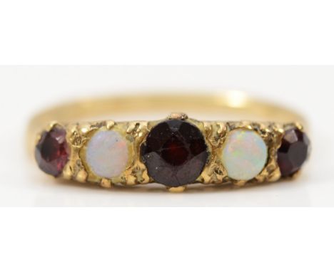 A 9ct gold garnet and opal dress ring, M, 2.2g