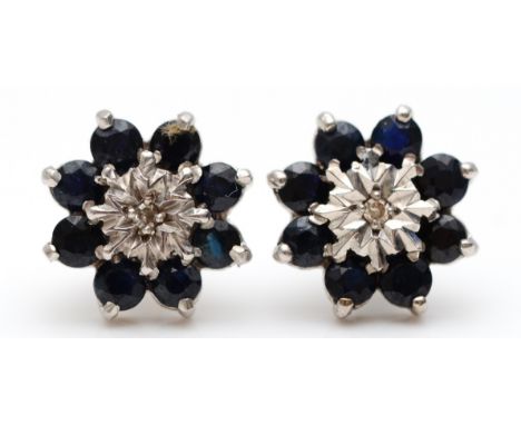 A pair of 9ct white gold diamond and sapphire cluster earrings, 12mm across, 2.5g