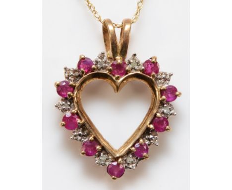 A 9ct gold ruby and diamond heart shaped pendant with a chain, 18mm across, 2.7g