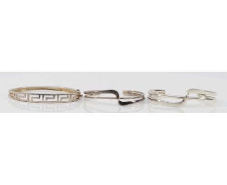 A silver Greek Key pattern hinged bangle, 62 x 47mm, a silver crossover bangle and a 925 silver crossover bangle 52gm, (3)
