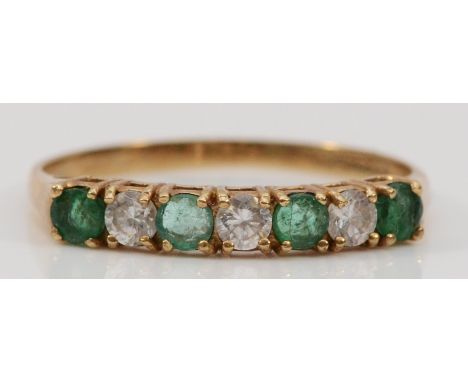 A 9ct gold emerald and CZ seven stone ring, Q, 1.3gm