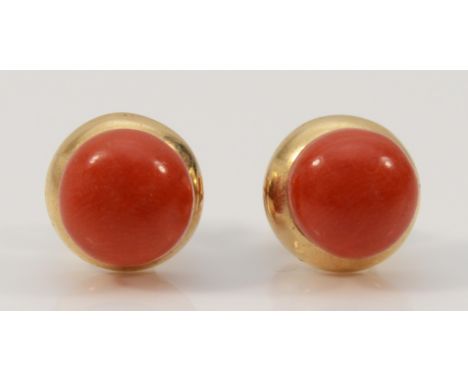 A pair of 9ct gold coral stud earrings with scroll backs, 7mm diameter, 2.4g