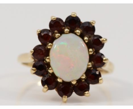 A 9ct gold opal and garnet cluster ring, 10mm x 7mm opal, R, with original box and receipt, 4g