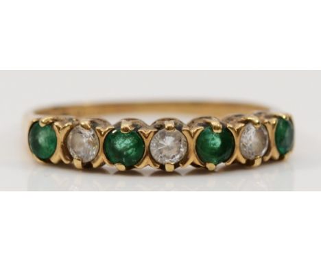 A 9ct gold emerald and cubic zirconia half eternity ring, K, 1.3g