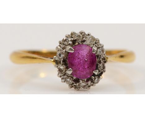 An 18ct gold ruby and diamond cluster ring, dated 11.4.61 to the inside, M, 2gm