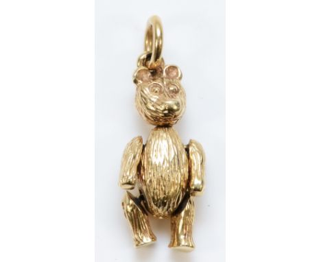 A 9ct gold pendant in the form of a bear with articulated arms and legs and movable head, 23mm length, 4.1g