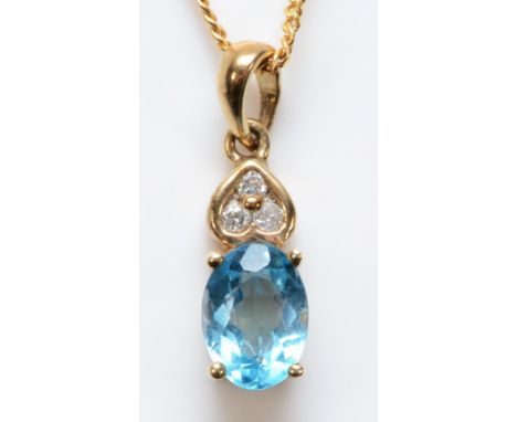 A 9ct gold blue topaz and brilliant cut diamond pendant, 15mm, 44cm chain, 2.5gm