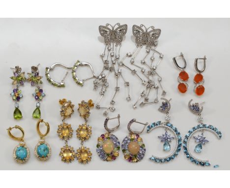 Eight pairs of silver and gemstone set ear rings, including opal and peridot, the butterflies 8.5cm long, one blue stone loos