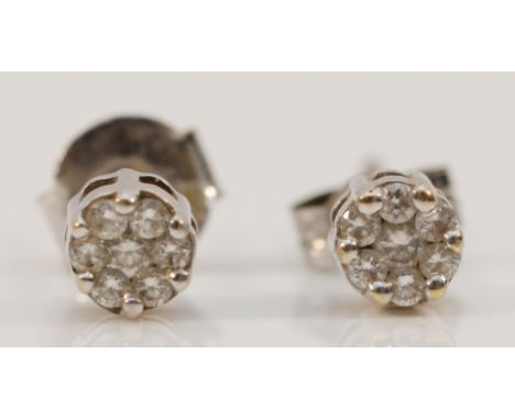 A pair of 9ct white gold diamond cluster earrings with scroll backs, 1g