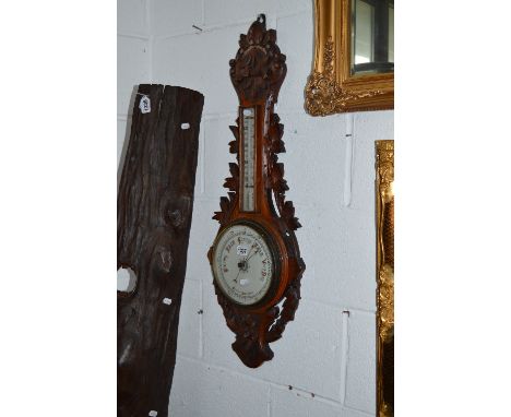 A CARVED OAK ANEROID BAROMETER, with foliate detail