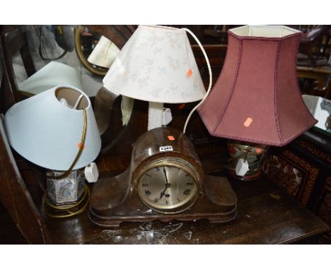 AN OAK CASED MANTLE CLOCK, three various wall mirrors and four various table lamps, sd  (8)