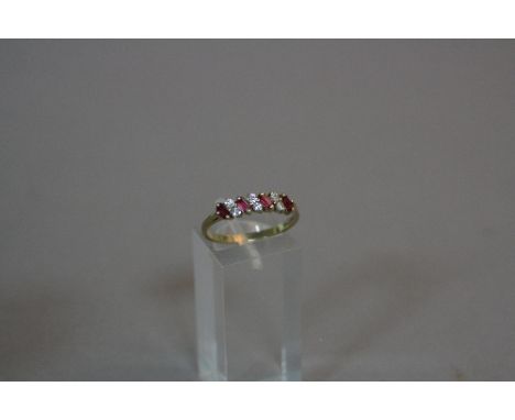 A 9CT RUBY AND DIAMOND SEVEN STONE RING, ring size R, approximate weight 2.1 grams