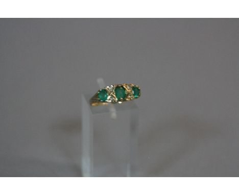 A 9CT EMERALD AND DIAMOND RING, ring size K, approximate weight 2.6 grams