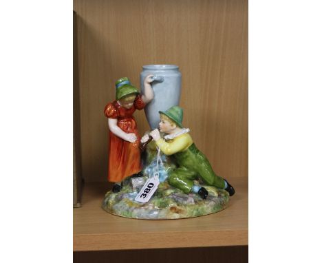 A ROYAL WORCESTER FIGURE GROUP, depicting a boy kneeling down playing a horn, with a young girl stood beside him, leaning on 