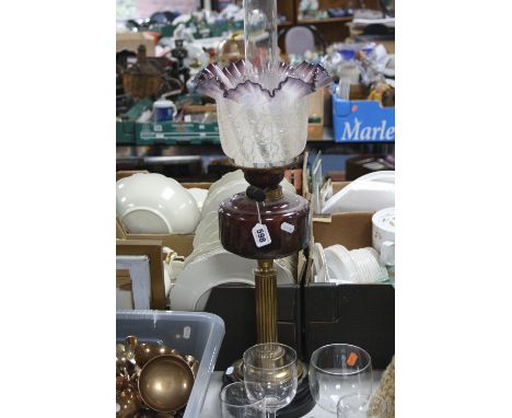 A LATE VICTORIAN OIL LAMP, the opaque glass shade with crackle moulding and wavy amethyst rim, amethyst glass reservoir, bras