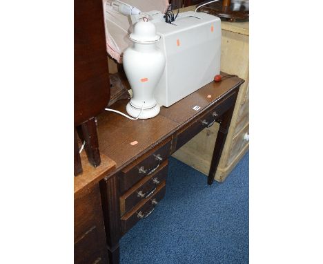 AN ELECTRIC SEWING MACHINE ON AN OAK FRAME, oak tea trolley, two standard lamps, magazine rack and a table lamp (7)