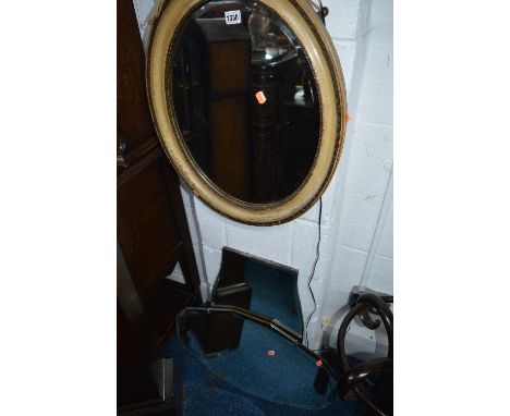 A CARVED CIRCULAR ANEROID BAROMETER, oval bevelled wall mirror and two other wall mirrors (4)