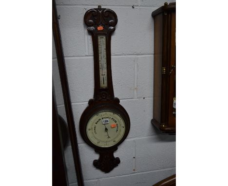 A CARVED OAK ANEROID BAROMETER, W A Perry & Co, Birmingham
