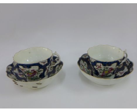 Pair of Dr Wall Worcester cups and saucers, in exotic bird pattern to a blue scale ground, one saucer with stapled repair (4)