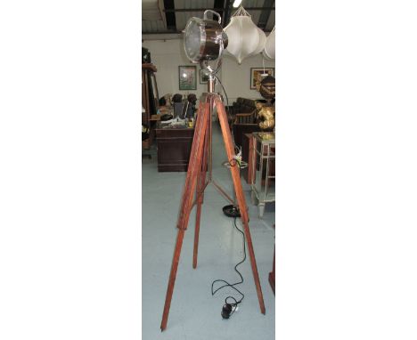 STUDIO LAMP, in chromed metal on an extending wooden tripod support, 183cm H.
