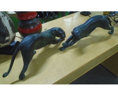 BRONZE LIONESSES, a pair, in a verdigris finish, 62cm L. (2)